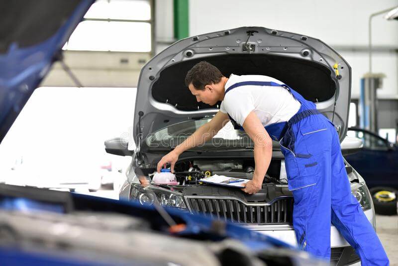 A mechanic is opening a coolant box of Audi car in a mechanic's shop – German Car Depot A mechanic is opening a coolant box of Audi car in a mechanic's shop