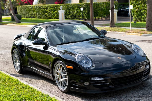 A Porsche 911 Turbo S parked on a road – German Car Depot A Porsche 911 Turbo S parked on a road