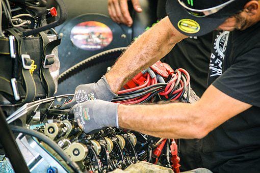A mechanic is repairing a battery of Volkswagen car