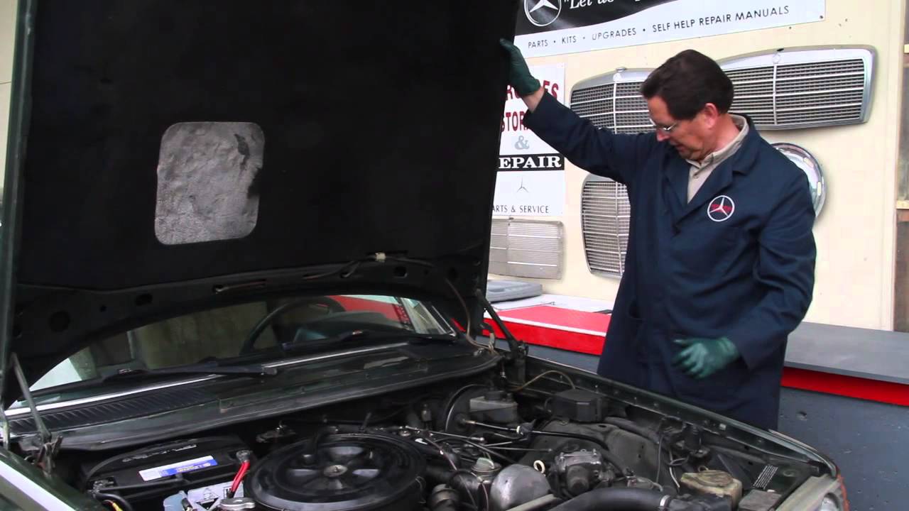 A mechanic checking mercedes car engine