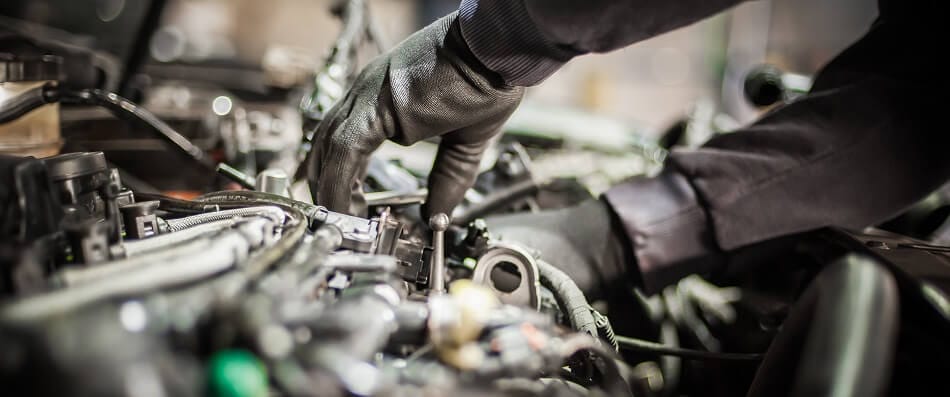 A mechanic is repairing a car – German Car Depot A mechanic is repairing a car