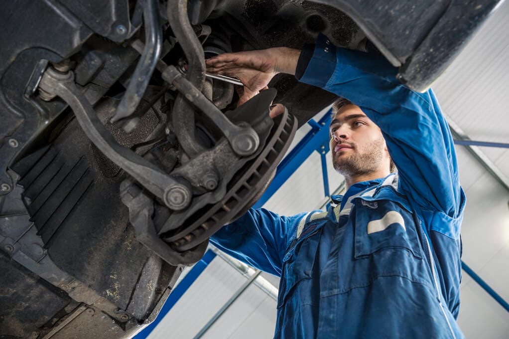 A mechanic is repairing a car – German Car Depot A mechanic is repairing a car