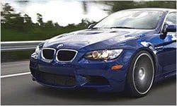 A blue color BMW M3 car running fast on a car