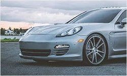 A Grey color Porsche Panamera car parked on a road
